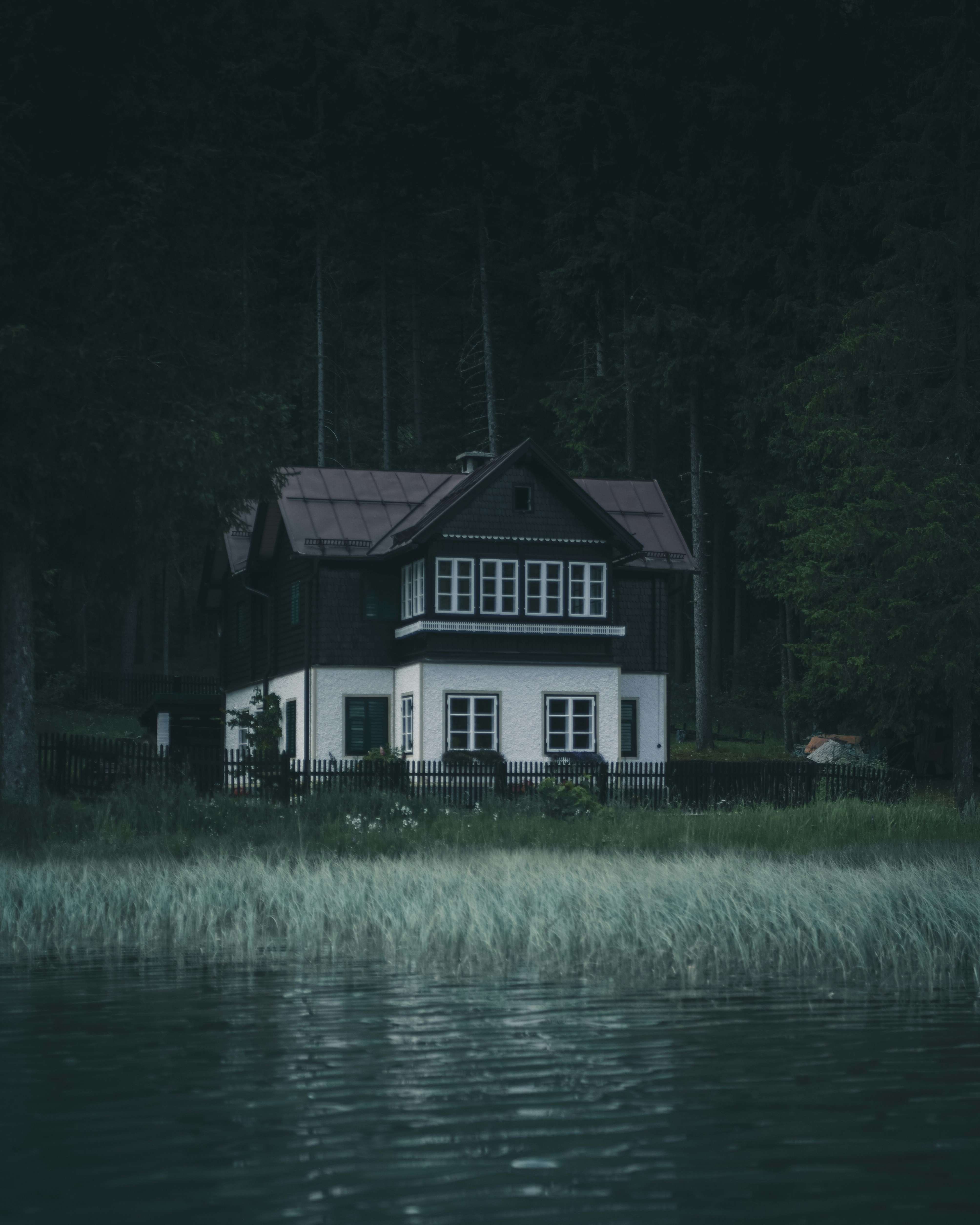 black and white house near body of water
