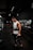 man in white tank top holding bumper plate