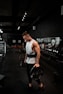 man in white tank top holding bumper plate