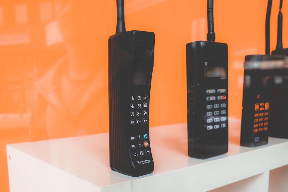 black home phones on white rac k