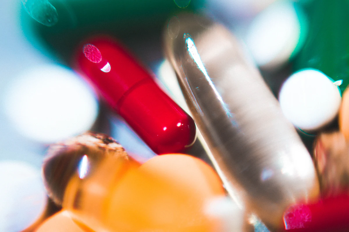 Close-up of probiotic supplement capsules arranged on a plain surface