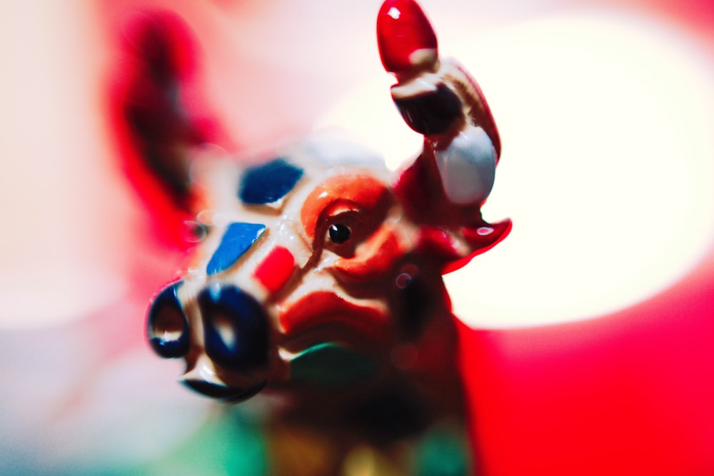macro photography of brown and white bull figurine