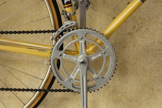 yellow bicycle with grey pedal sprocket