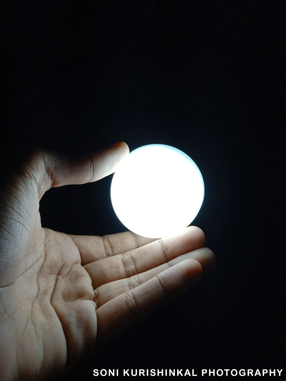 person holding ball of light