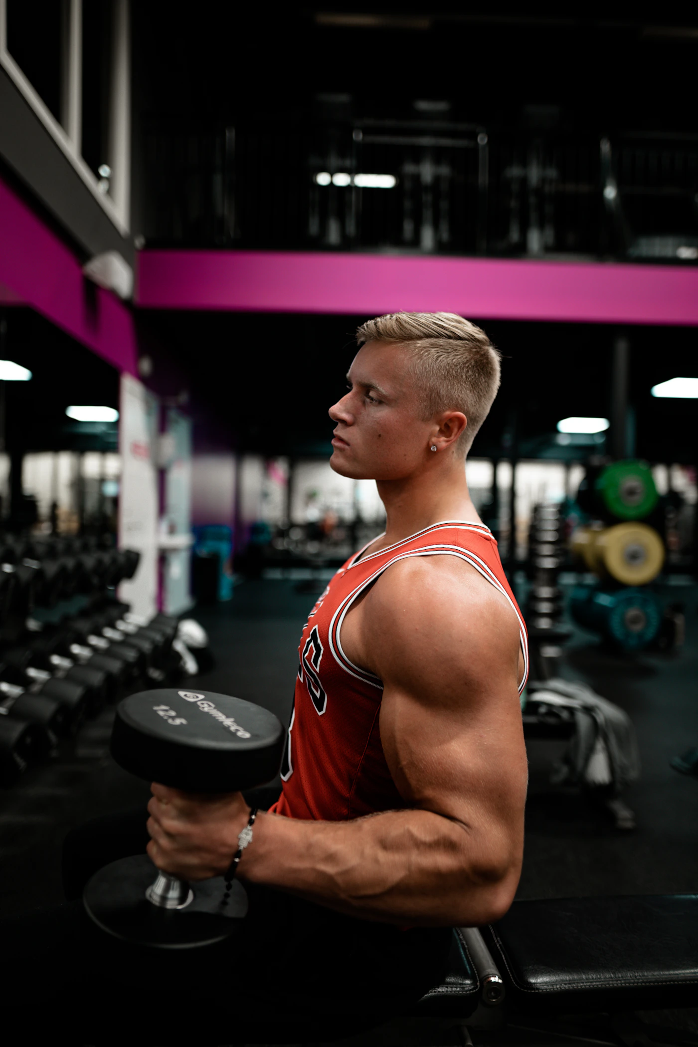 Athlete training with a dumbbell in a gym