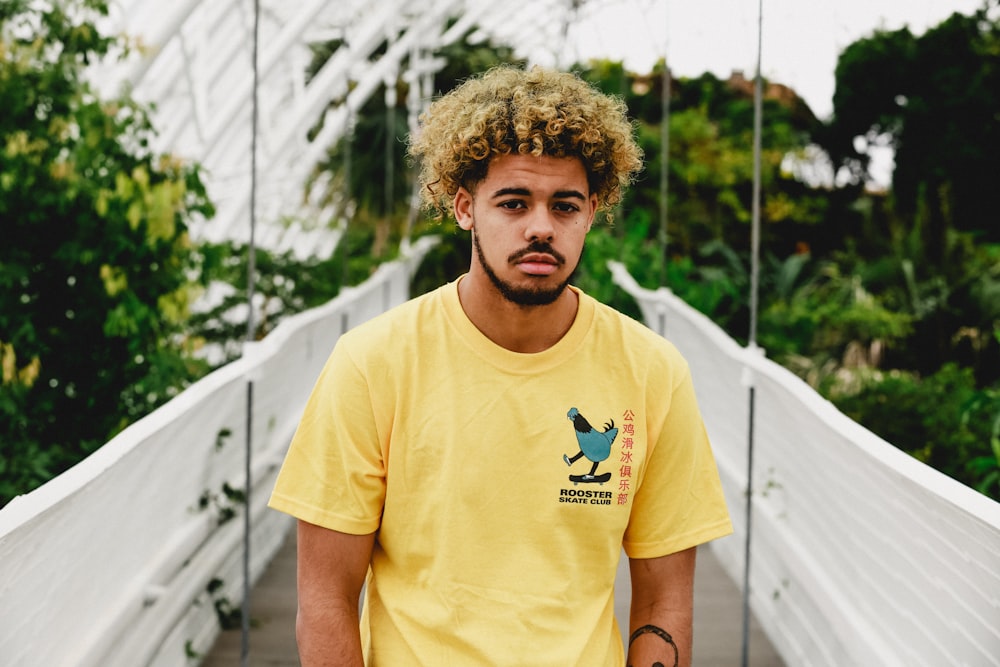 man in yellow t-shirt on bridge