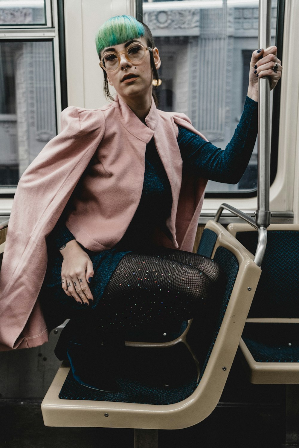 woman in pink blazer sitting in vehicle