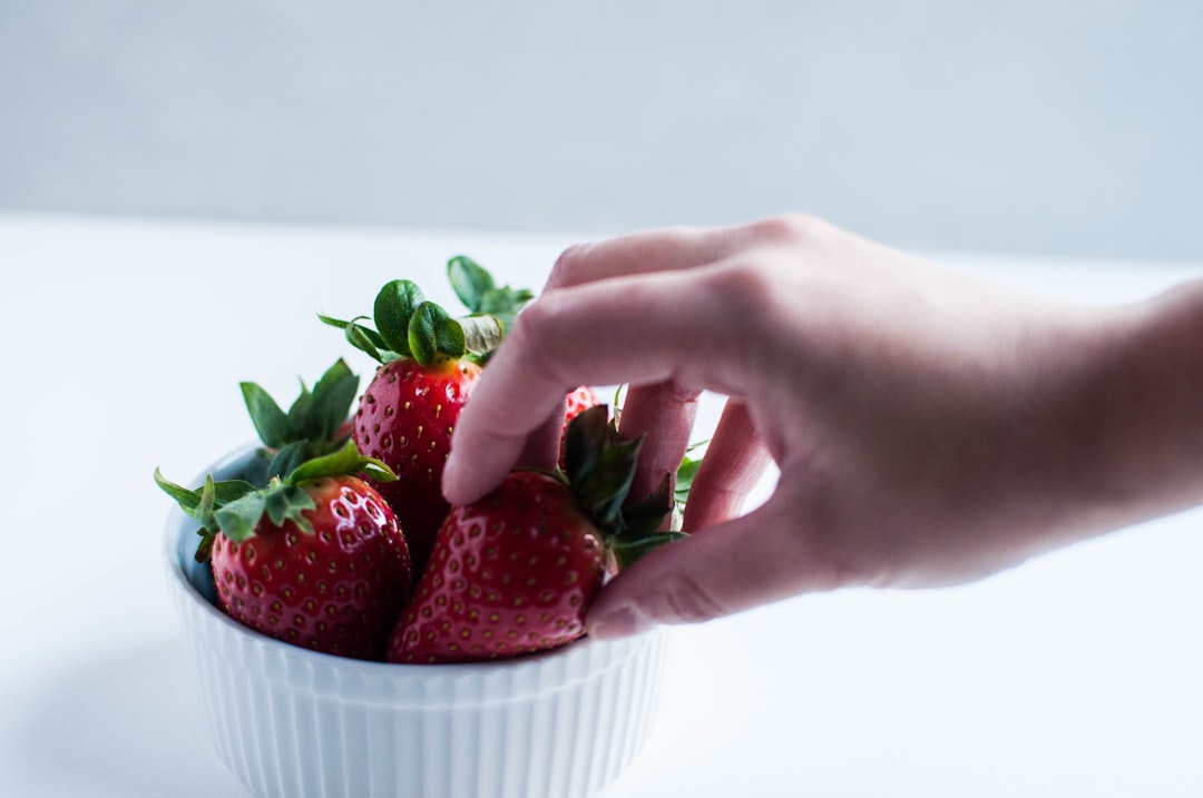 red strawberries on bowl