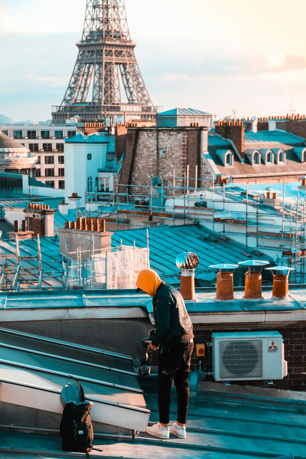 person standing near AC condenser during daytime