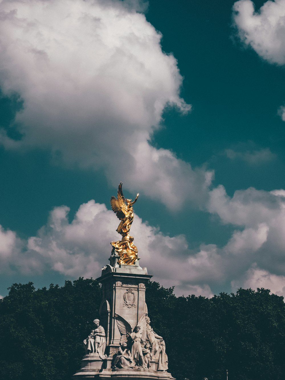 grey and gold monument under white cloudy sky