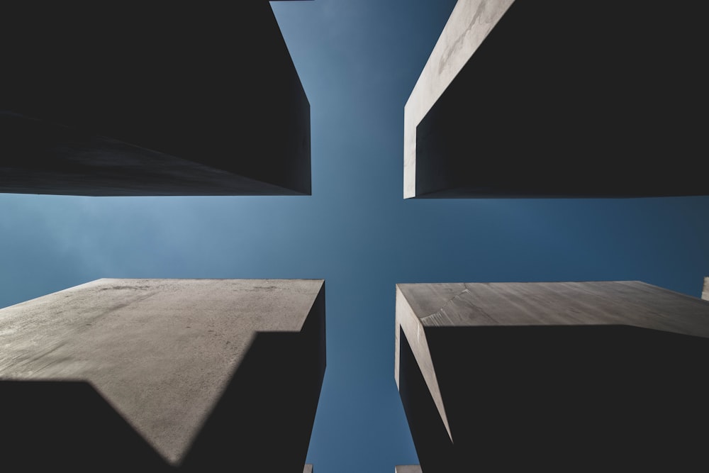 low angle view of four highrise buildings under clear sky