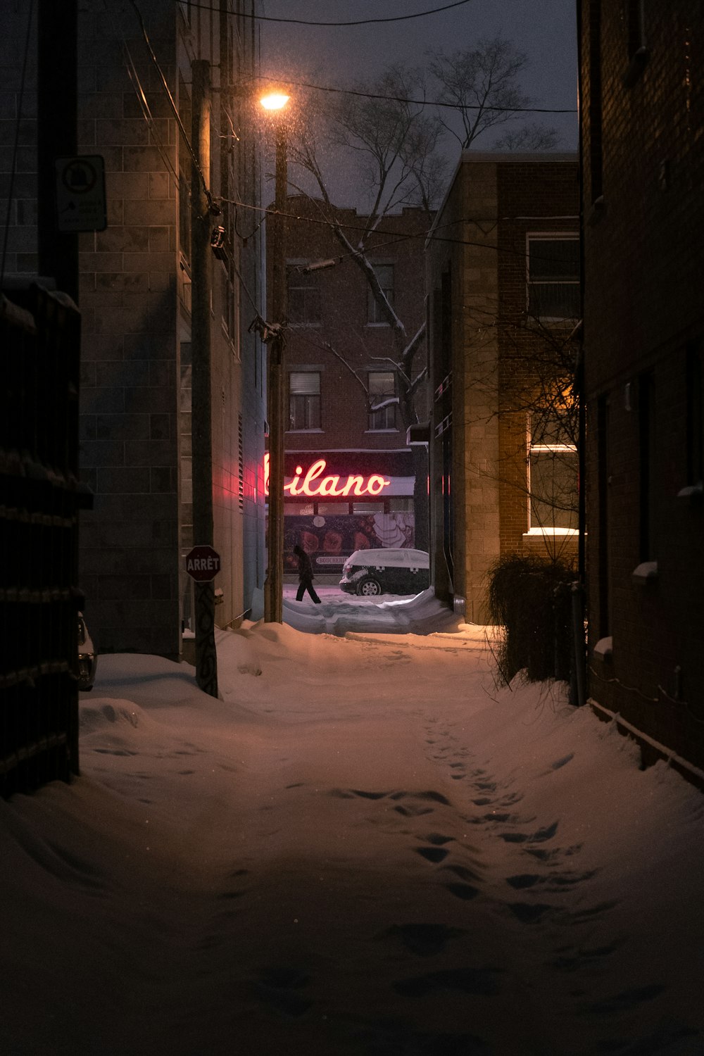 person walking near car and buildings