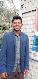 Smiling man wearing Steve Mason shoes and a casual jacket, standing outdoors.