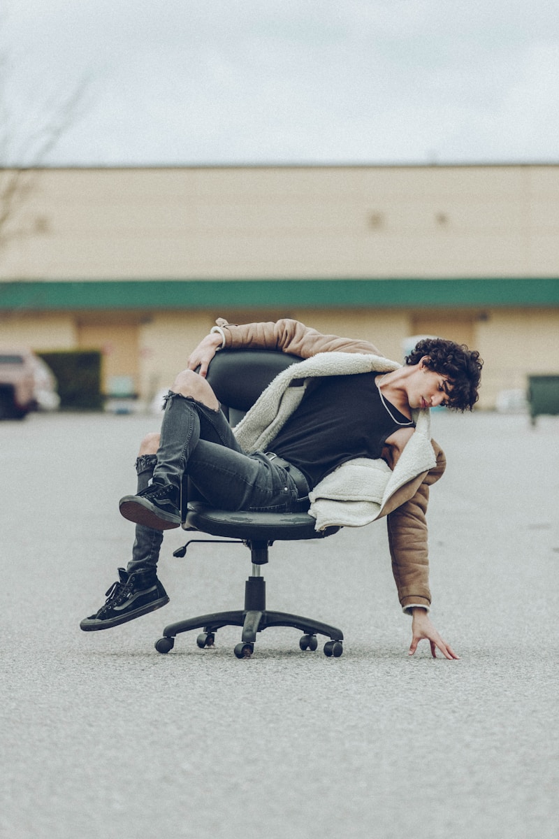 Man stretching at office chair, taking an active break between work sessions
