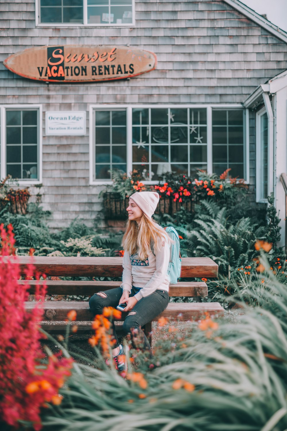 woman sitting on brown bench near Sunset Vacation Rentals