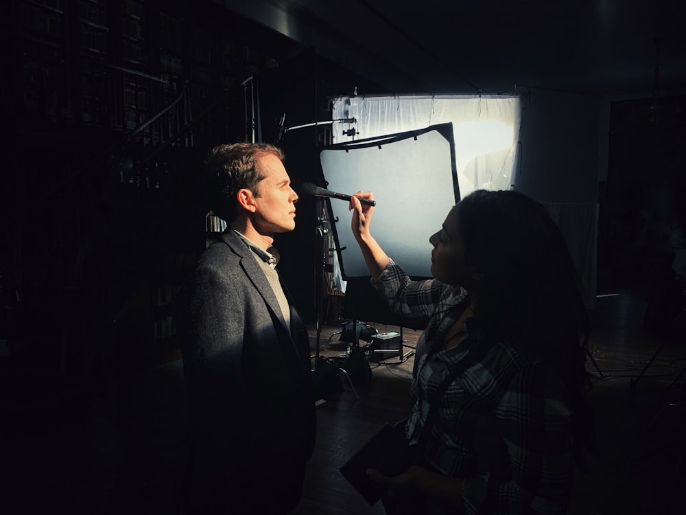 man standing beside woman inside room