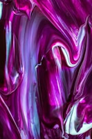 a close up of a purple and white abstract painting