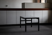 A beautifully finished custom wooden table in a bright, minimalist room.