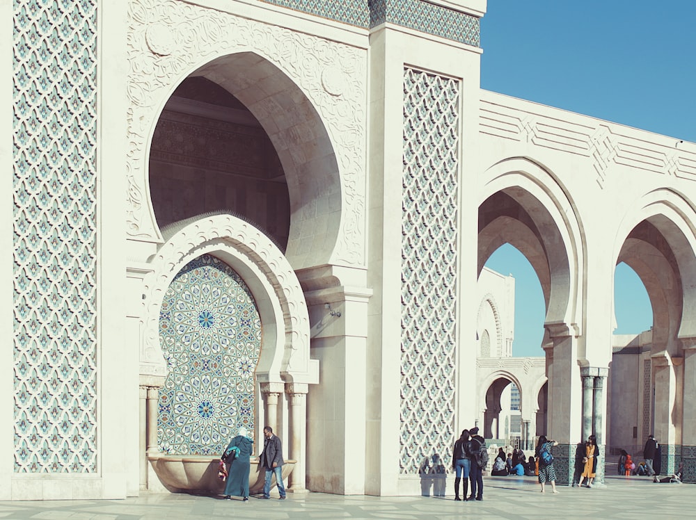 people walking beside triumphal arch