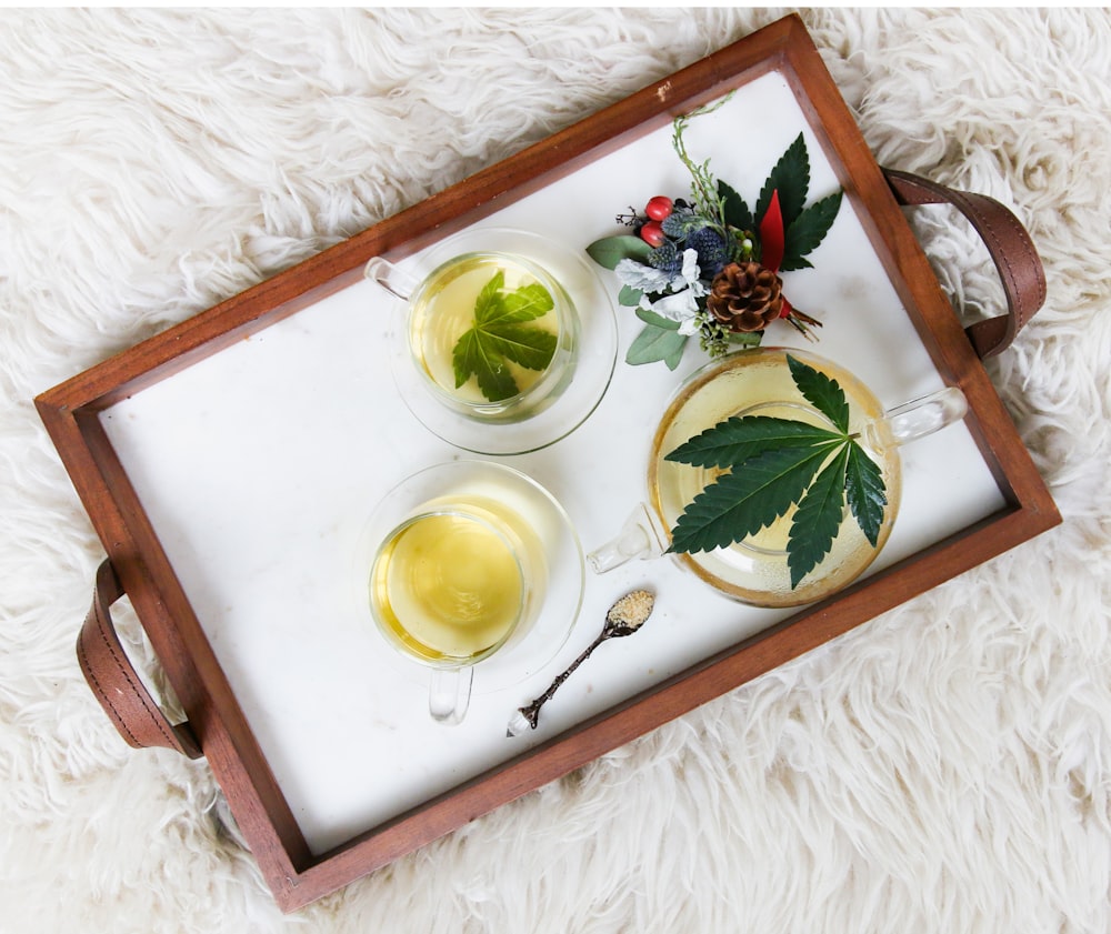 rectangular brown wooden tray filled with tea