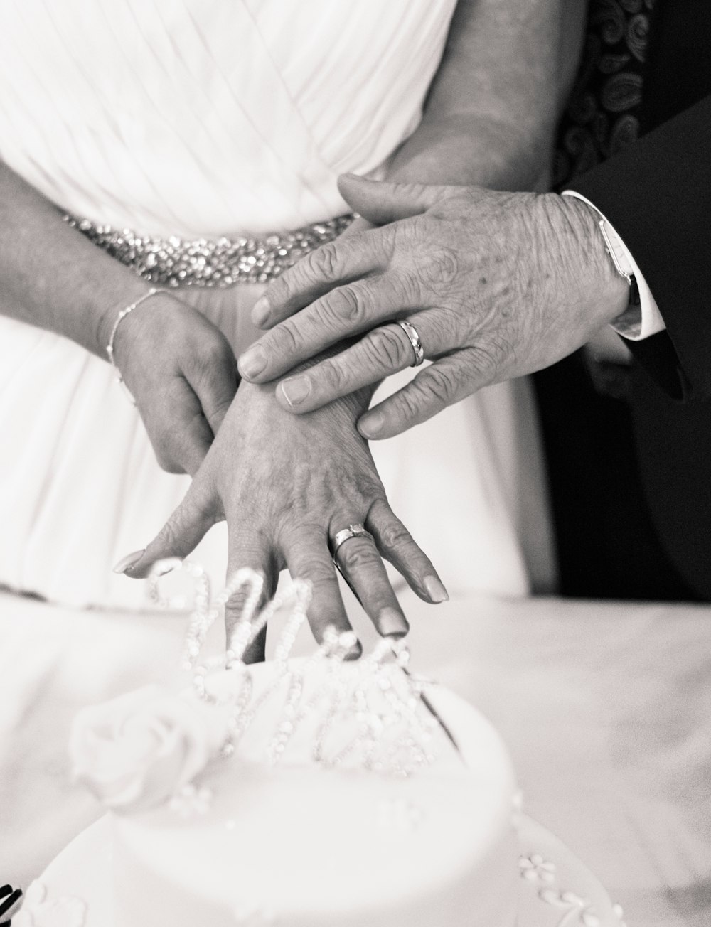 grayscale photography of wedding couple hands