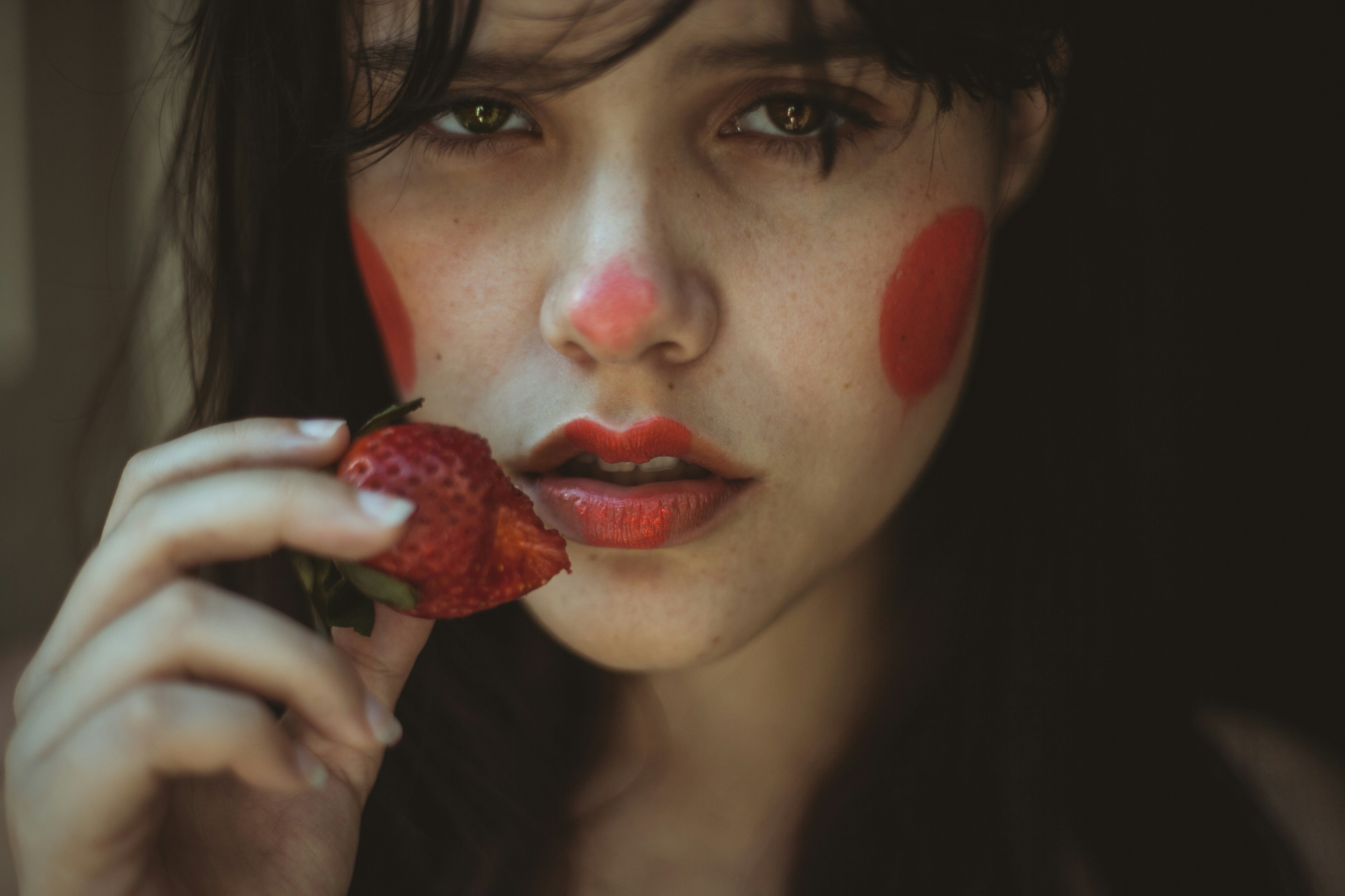 woman holding strawberry fruit
