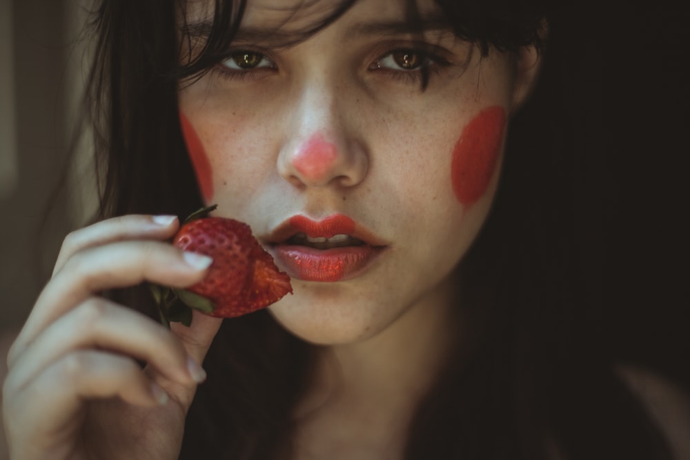 woman holding strawberry fruit