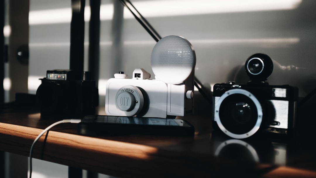 white and black cameras on top of table