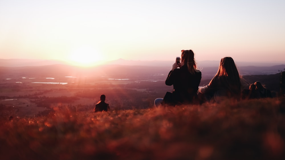 two person sitting on field