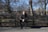 A peaceful park bench where a young person reflects thoughtfully on their relationship decisions.