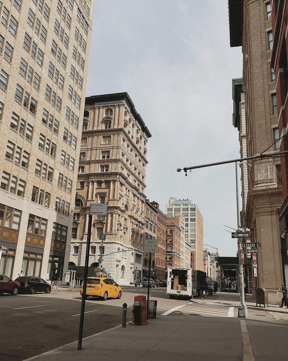 vehicle passing on road between buildings