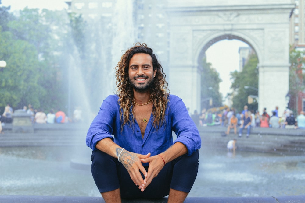 man smiling near fountain water