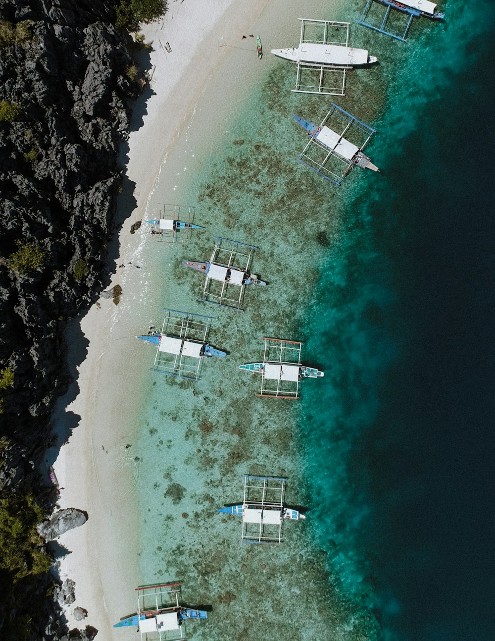 aerial photo of boats docked beside islet