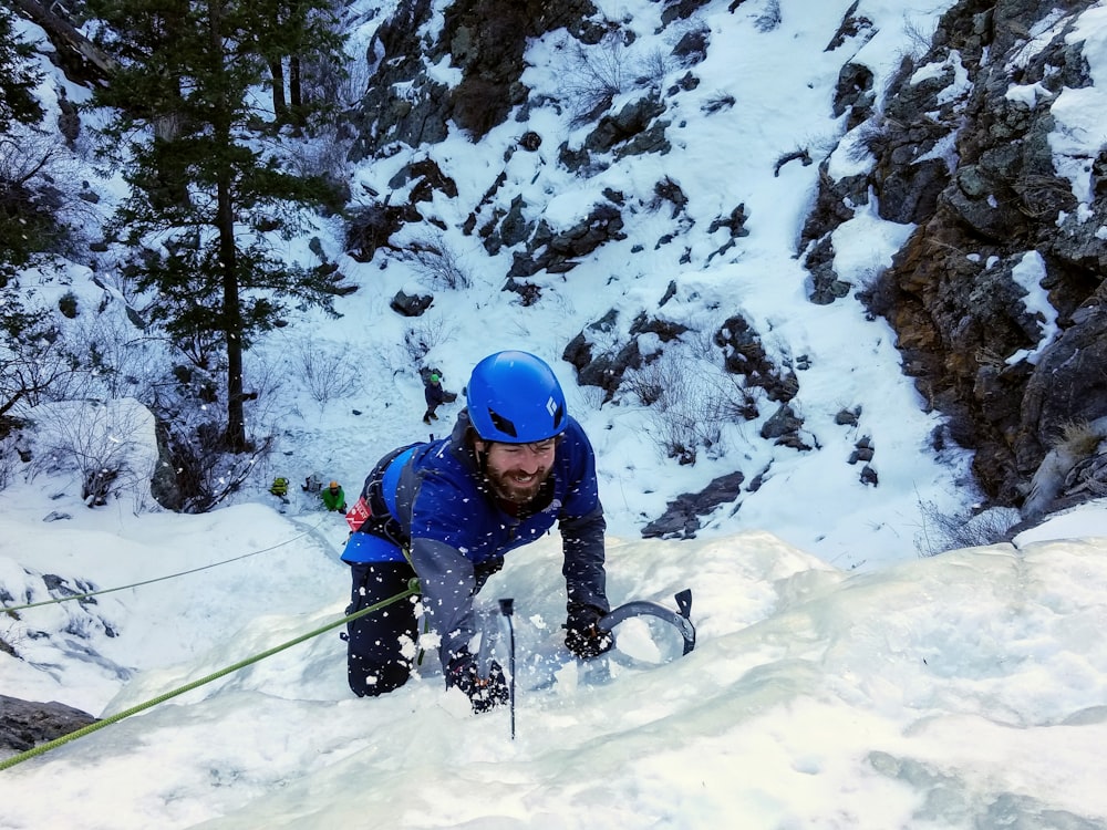 man climbing on snow mountain