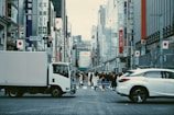 people walk in road with Japan flag in building