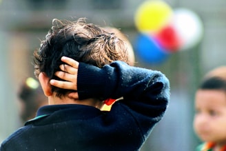 child putting right hand on back