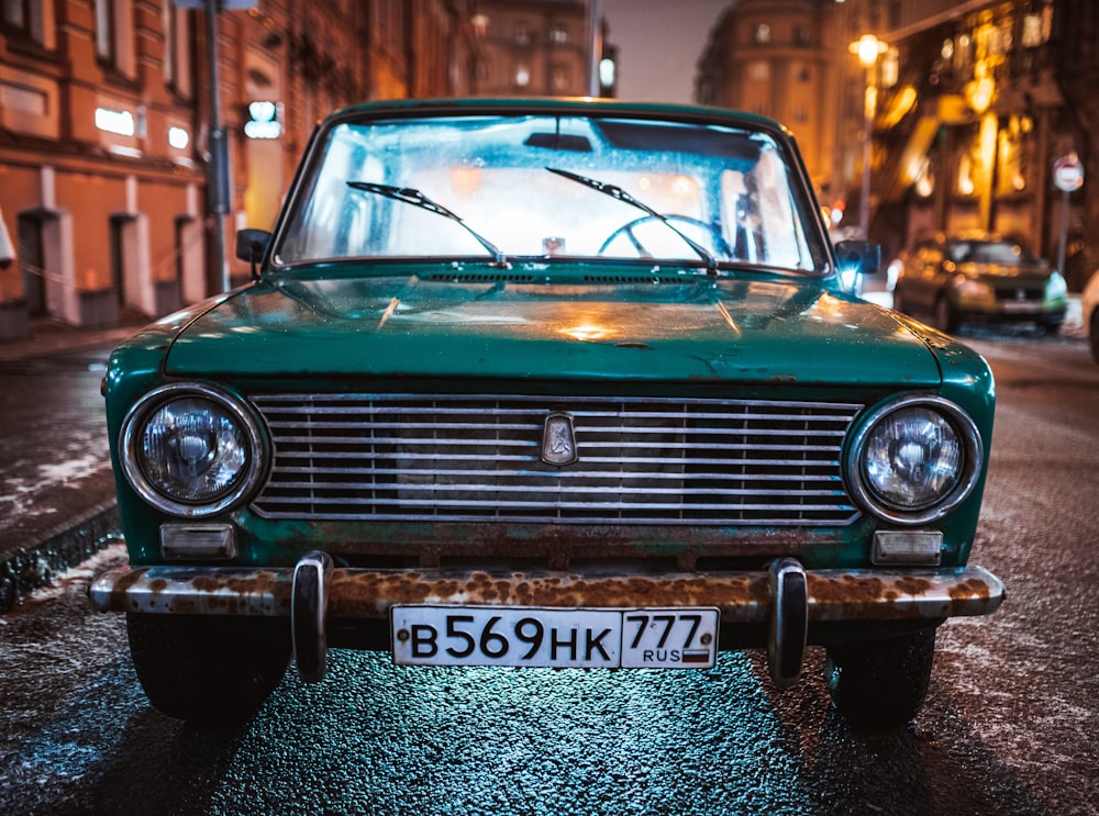 green Tofas Murat parked on roadside during nighttime