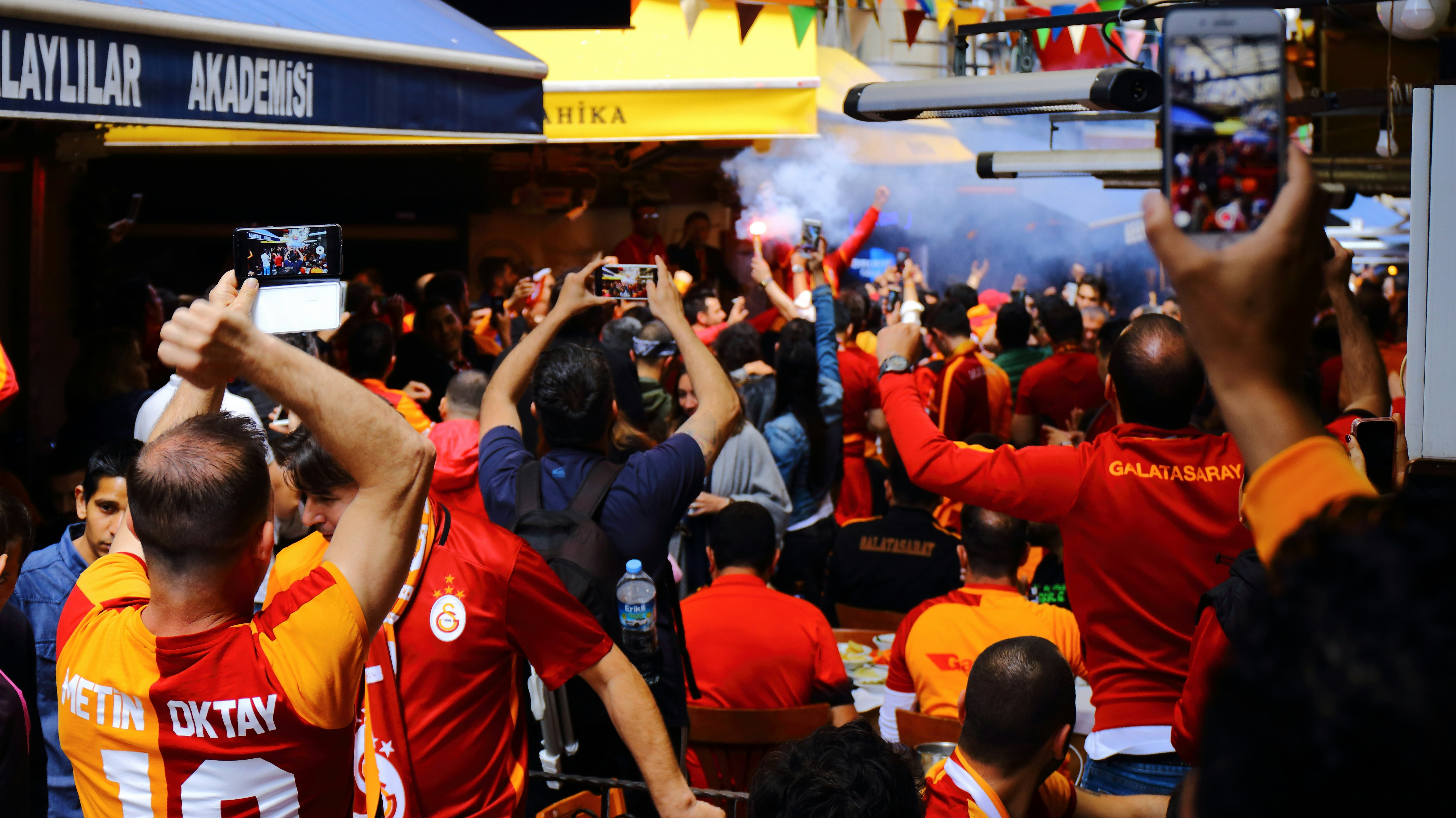 European football tournament highlights with fans celebrating in colorful jerseys