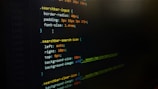 A screenshot of CSS code on a dark background, featuring styling rules for search bar elements such as border-radius, padding, and font size. Colored highlights emphasize syntax, with properties and values outlined in purple, orange, and green.
