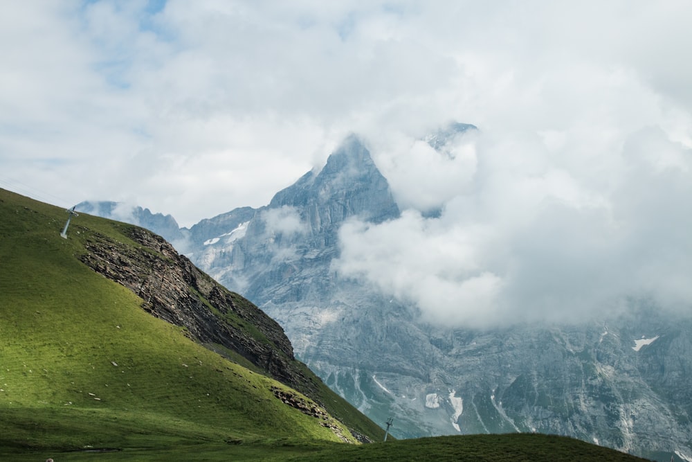 mountain with clouds during daytime