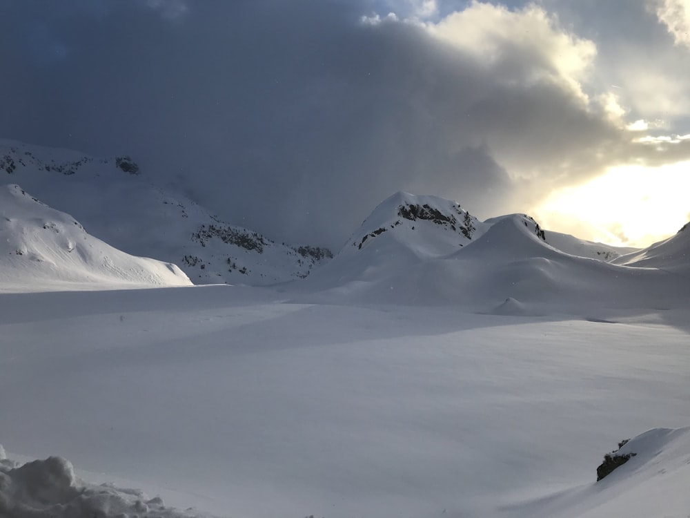 snow capped mountain under white clouds