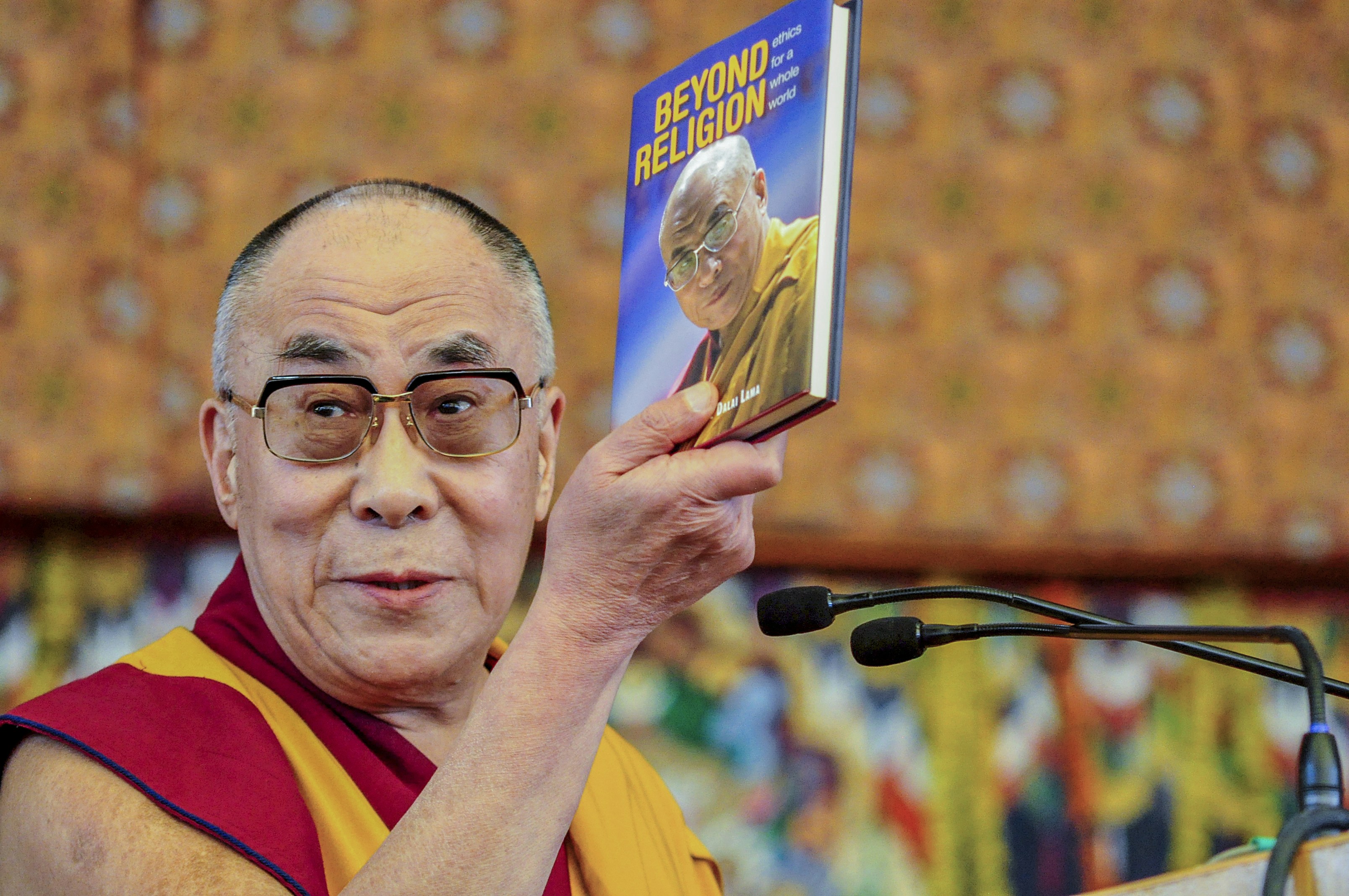 Man holding Beyond Religion book