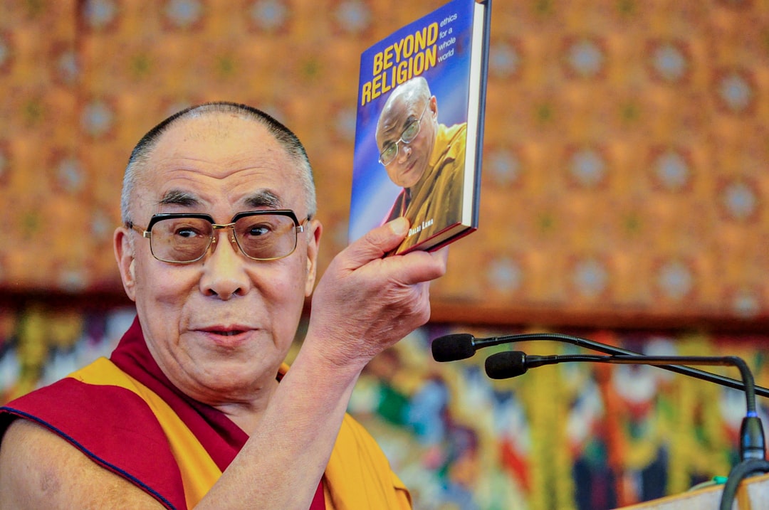 Man holding Beyond Religion book