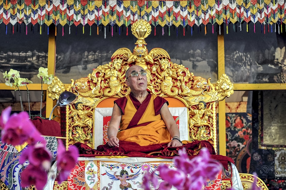 man sitting on altar at daytime