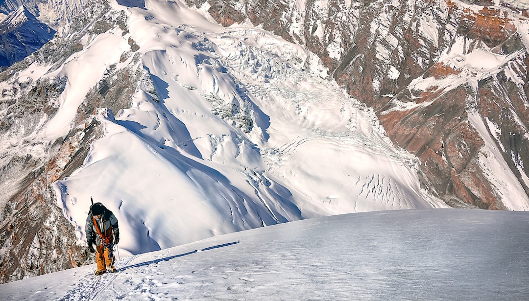 person standing on snow capped mountain