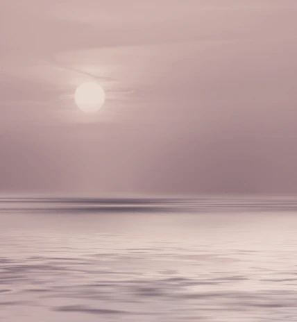 A gentle sunrise over calm water, symbolizing new beginnings and inner peace.