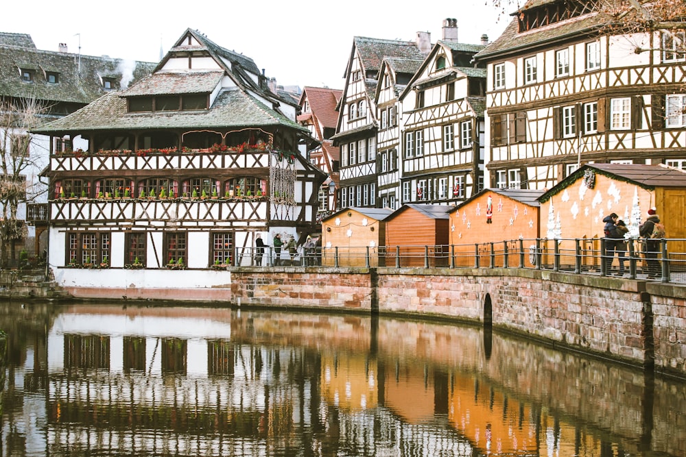 brown painted building near body of water