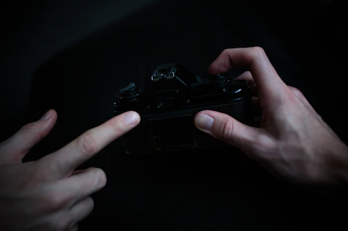 A close-up of hands gently restoring an old wedding photo with delicate tools and soft lighting.
