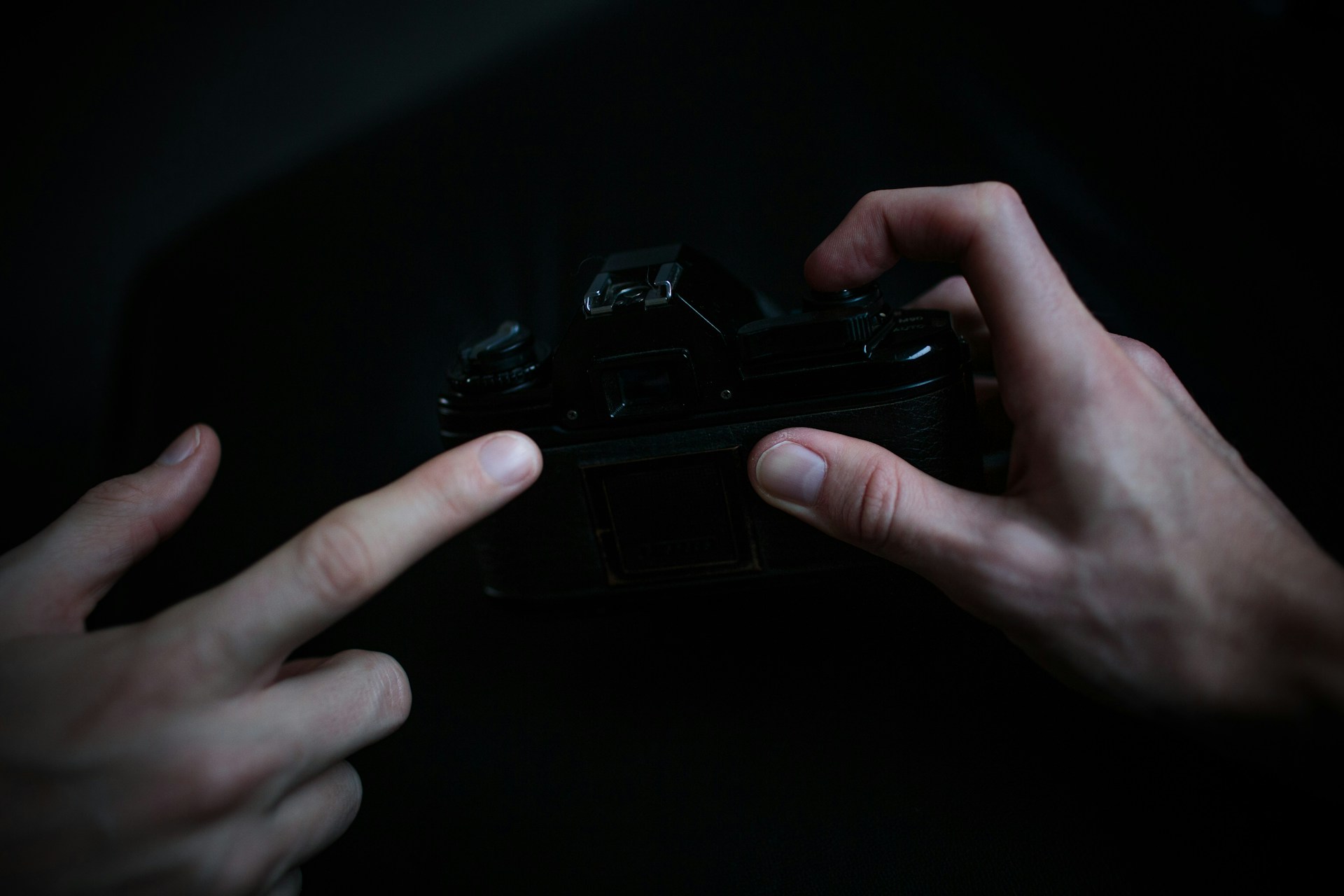 A close-up of delicate hands holding a vintage camera, symbolizing the poetic and visual sensitivity of haixama's work.