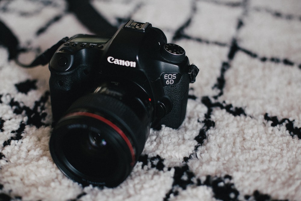 a camera sitting on top of a white rug